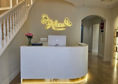 Reception area of By H Beauty Ladies Salon in Dubai, Dubai, AE with elegant decor and floral accents.