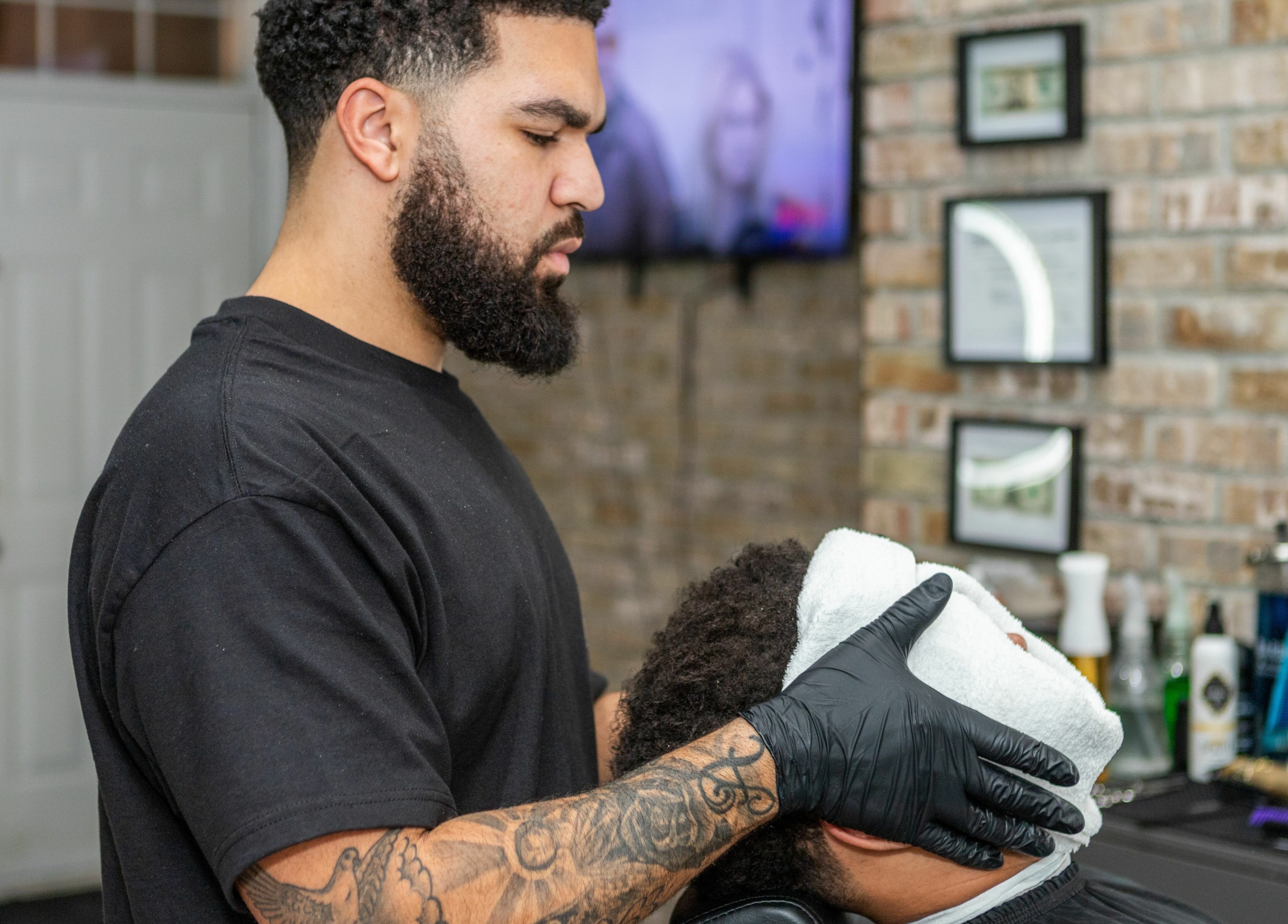 Barber at KustomCuts providing a hot towel service in Toronto, Ontario, CA.