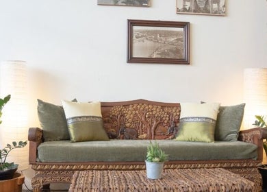 Elegant seating area at Golden Fingers Thai Massage - Morningside, Auckland, Auckland, NZ with carved wooden sofa.