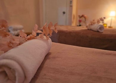 Relaxing massage room at Golden Fingers Thai Massage - Kingsland, Auckland, NZ, featuring cozy tables and soft lighting.