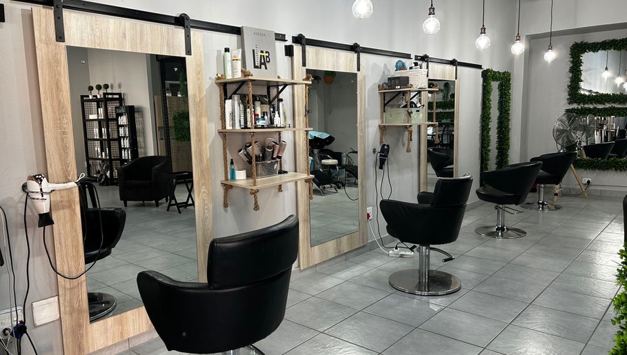 Modern salon chairs and mirrors at Envy Hair Design, Boksburg, Gauteng, ZA, showcasing sleek design and elegance.
