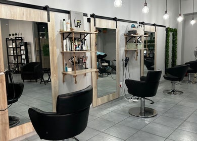 Modern salon chairs and mirrors at Envy Hair Design, Boksburg, Gauteng, ZA, showcasing sleek design and elegance.