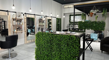 Modern salon interior at Envy Hair Design, Boksburg, Gauteng, ZA, featuring chic decor and greenery.