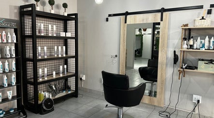 Envy Hair Design salon corner with styling products in Boksburg, Gauteng, ZA, featuring a mirror and chair.