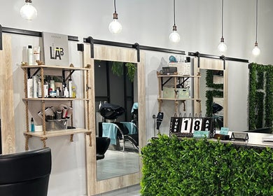 Modern interior of Envy Hair Design in Boksburg, Gauteng, ZA with stylish decor and greenery.