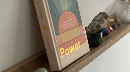 Book and sage on a wooden shelf at Lullaby Wellness, Hamlyn Terrace, New South Wales, AU promote relaxation.