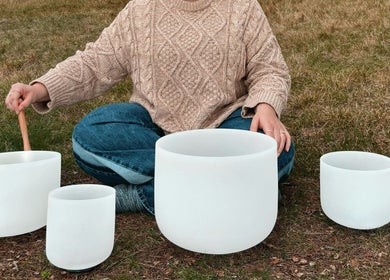A person playing crystal singing bowls at Lullaby Wellness in Hamlyn Terrace, New South Wales, AU.