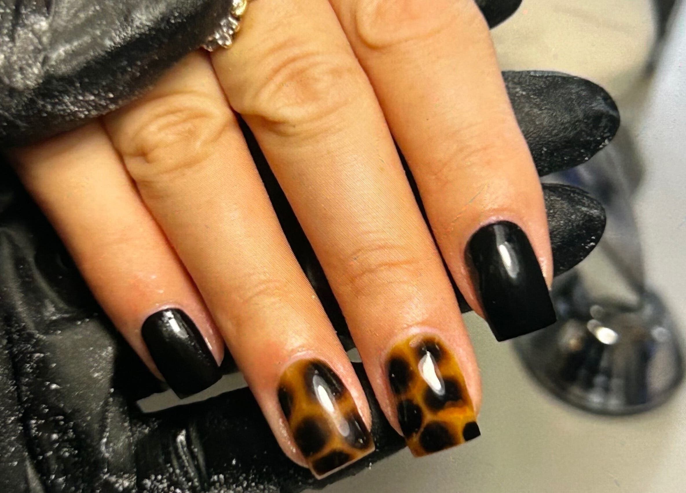 Stylish black and leopard print nails at Klass, Swinton, England, GB, showcasing unique nail artistry.