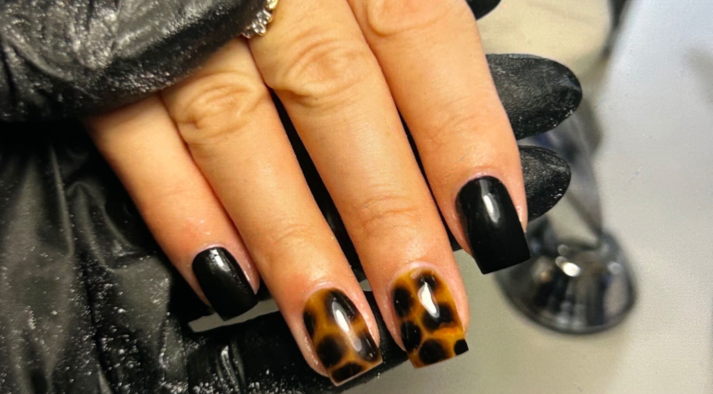 Stylish black and leopard print nails at Klass, Swinton, England, GB, showcasing unique nail artistry.