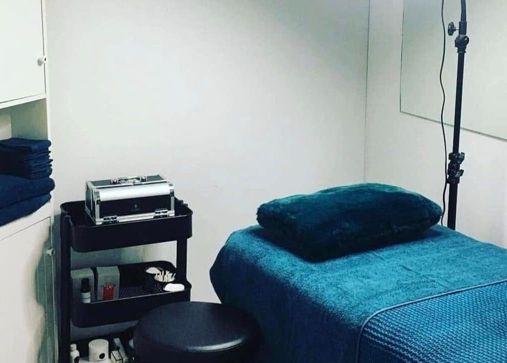 Relaxing treatment room at Glow With Elegant Faces, Scarborough, Western Australia, AU, with plush blue linens.