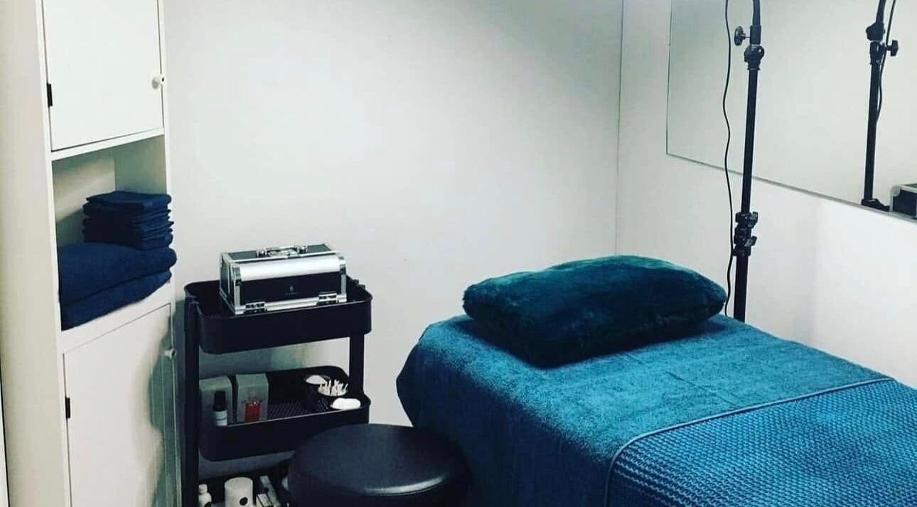 Relaxing treatment room at Glow With Elegant Faces, Scarborough, Western Australia, AU, with plush blue linens.