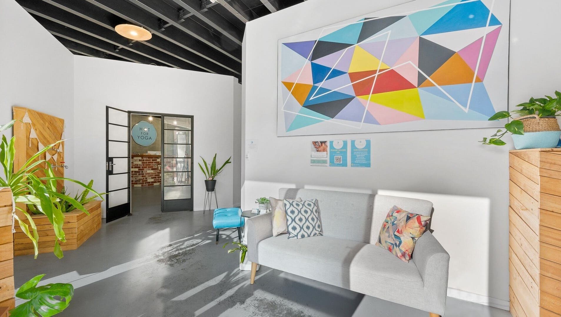 Inviting lounge at Bodyspace Recovery Studio, Jandakot, Western Australia, AU with art and vibrant plants.