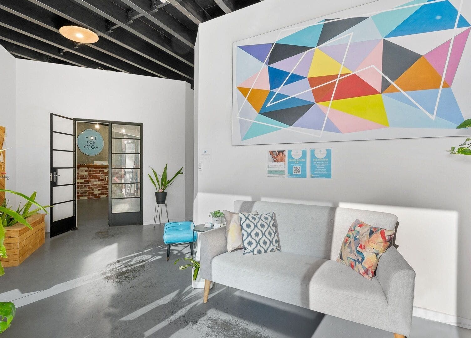 Inviting lounge at Bodyspace Recovery Studio, Jandakot, Western Australia, AU with art and vibrant plants.