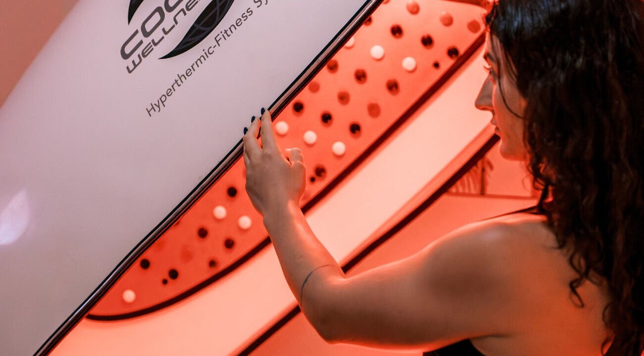 Woman adjusting an infrared wellness pod at Bodyspace Recovery Studio, Jandakot, Western Australia, AU.