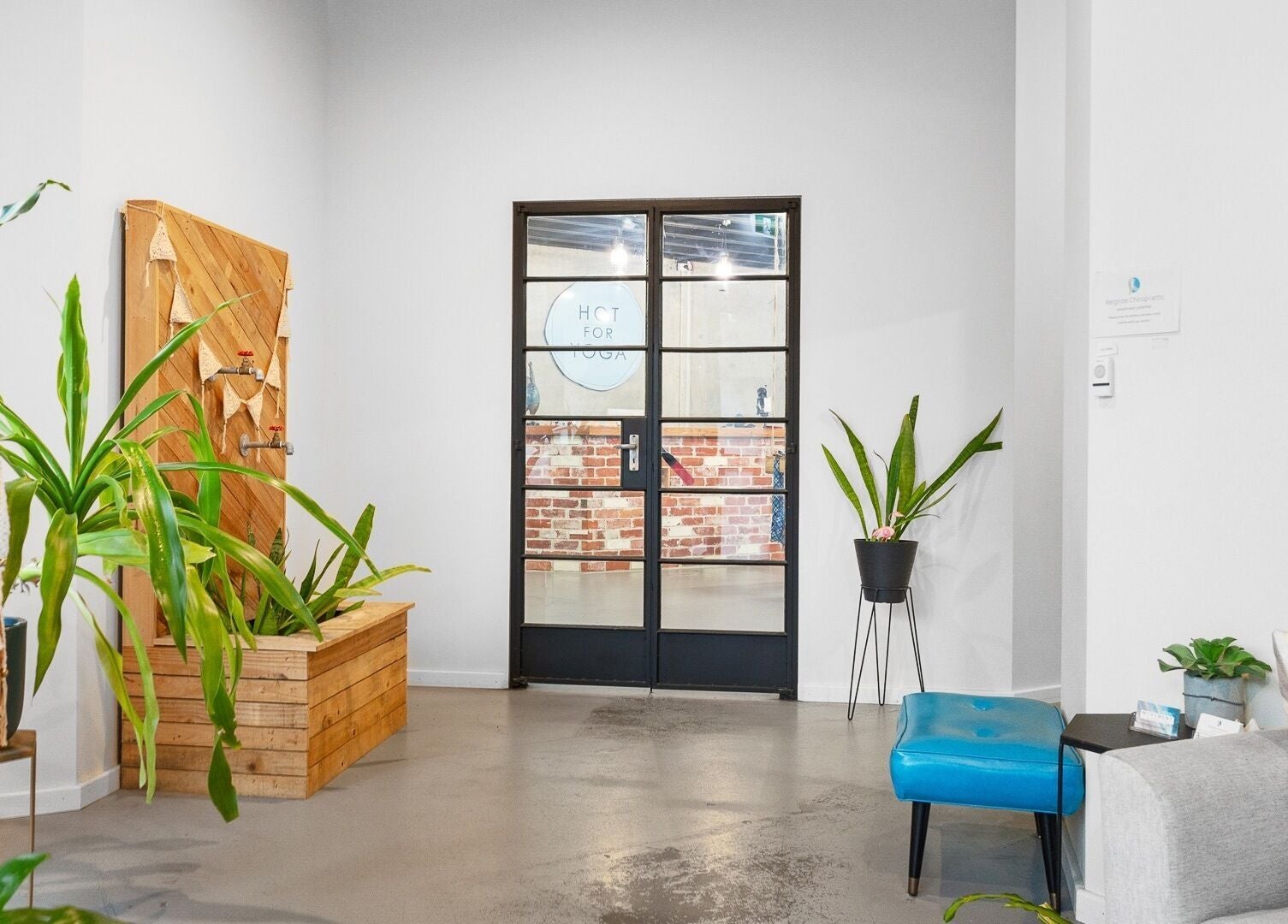 Inviting entrance of Bodyspace Recovery Studio, Jandakot, Western Australia, AU with plants and modern decor.