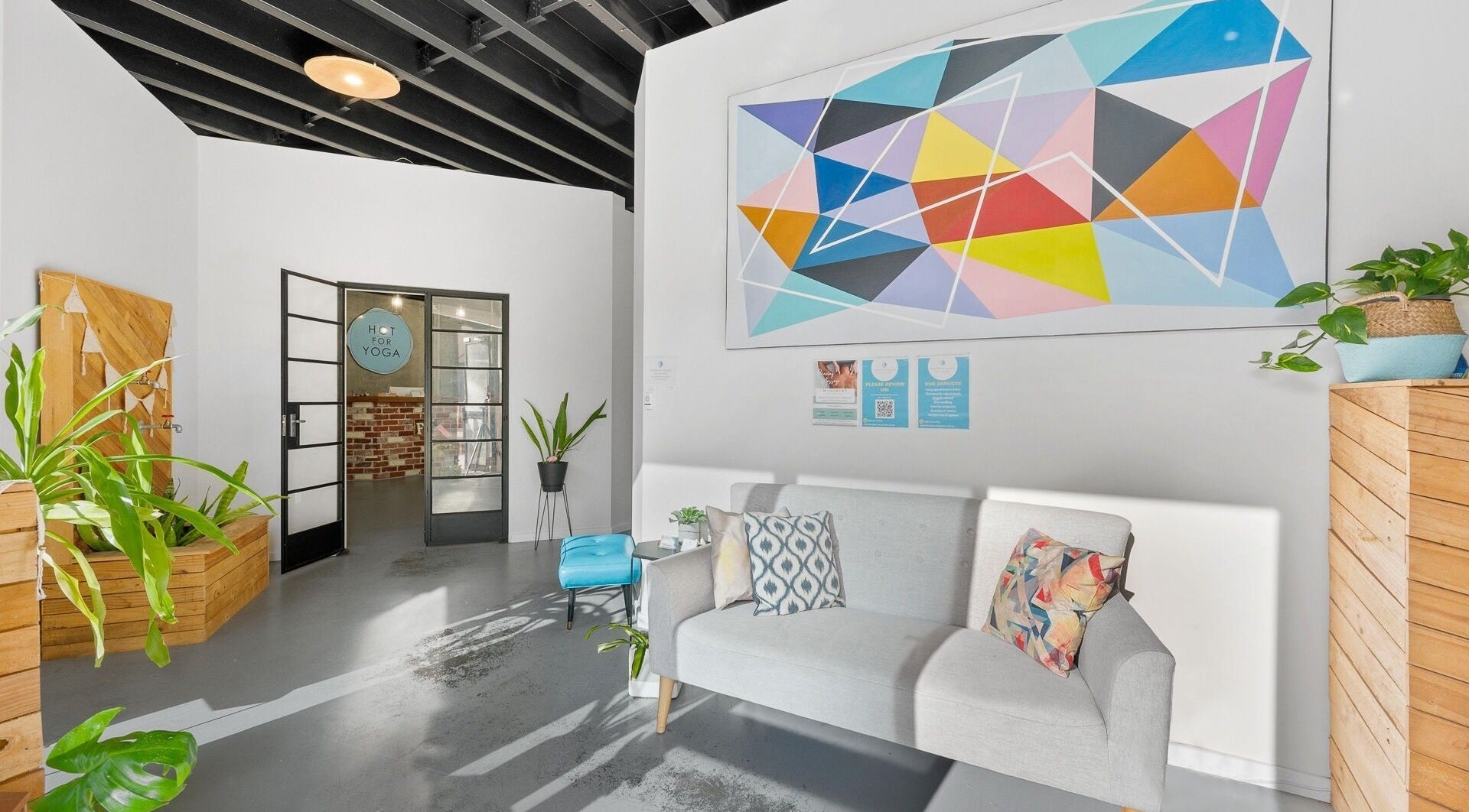 Stylish lounge area at Bodyspace Recovery Studio, Jandakot, WA. Bright decor and comfy seating.