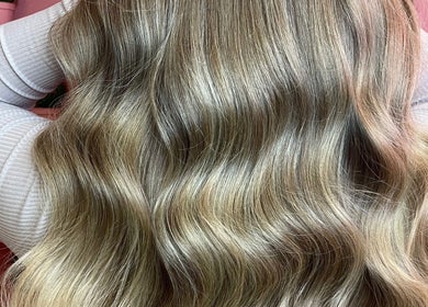 Lustrous wavy hair styled at JessicaLibbyHair, Hinckley, England, GB, showcasing professional hairstyling.