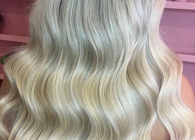 Soft, wavy silver hair styled at JessicaLibbyHair in Hinckley, England, GB showcasing expert coloring.