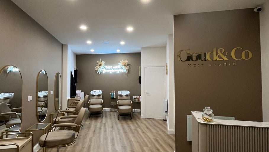 Interior of JessicaLibbyHair salon in Hinckley, England. Stylish chairs and mirrors create a modern, welcoming atmosphere.