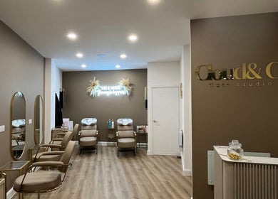 Interior of JessicaLibbyHair salon in Hinckley, England. Stylish chairs and mirrors create a modern, welcoming atmosphere.