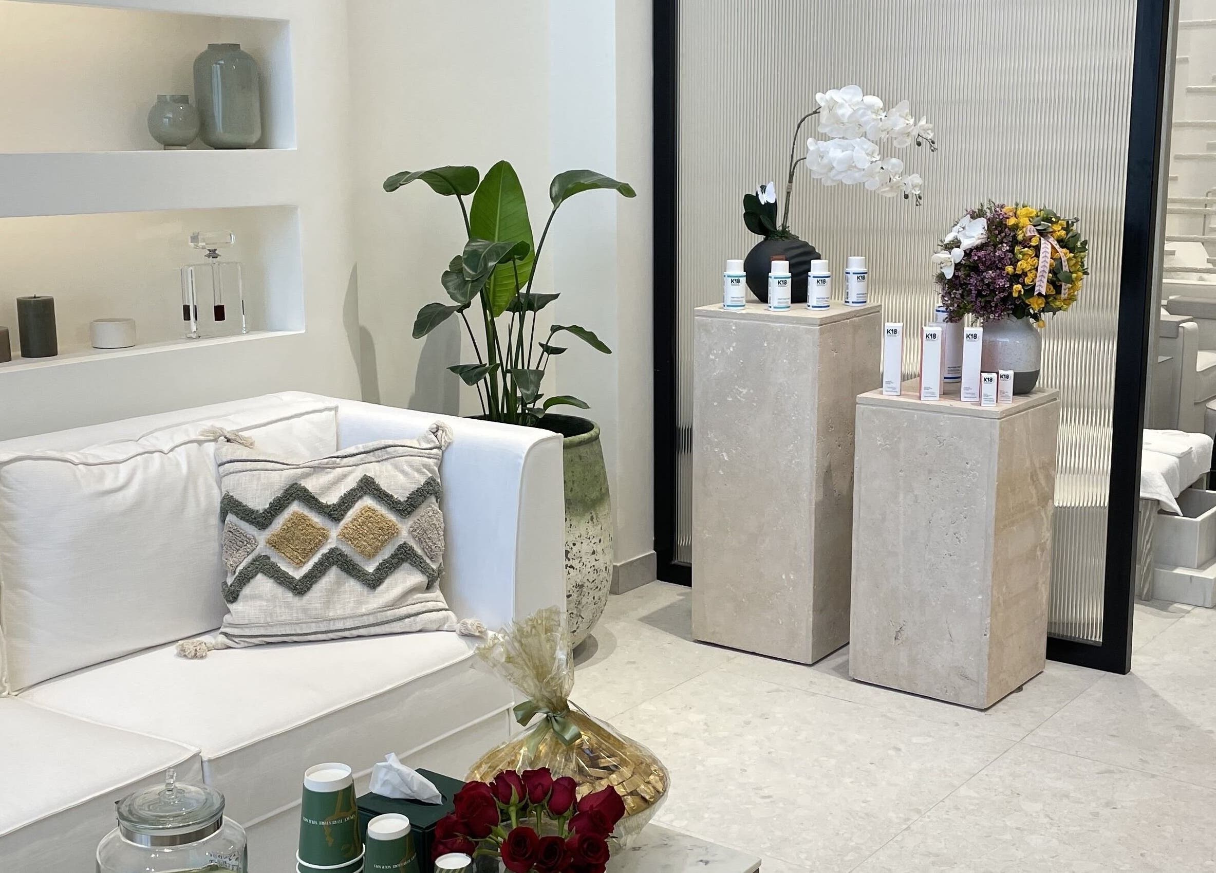 Elegant lounge area of Philautia Salon, Riyadh, with modern decor and floral accents for a relaxing atmosphere.