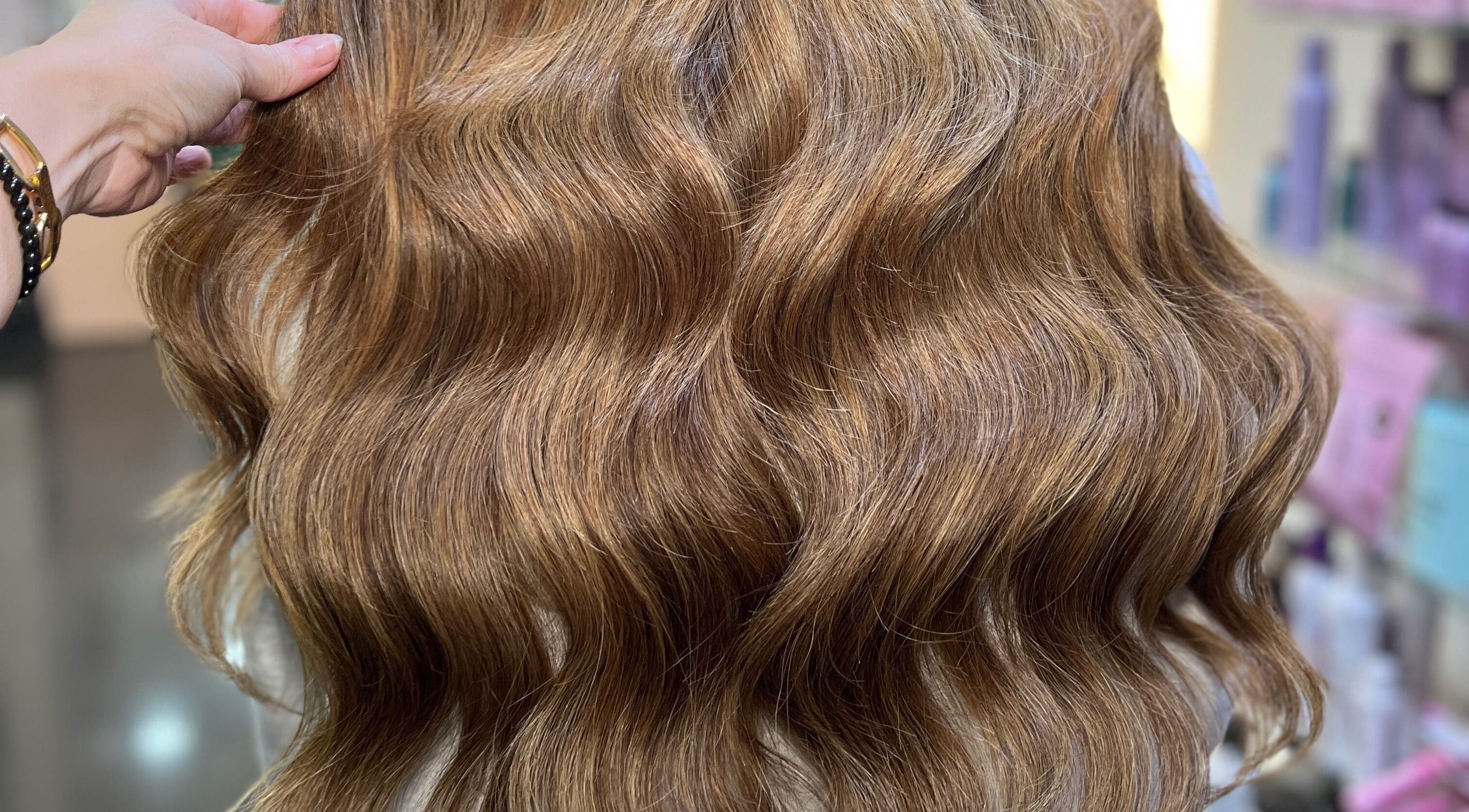 Luxurious golden hair extensions at Aura Extensions in Twickenham, England, GB, showcasing vibrant shine and volume.