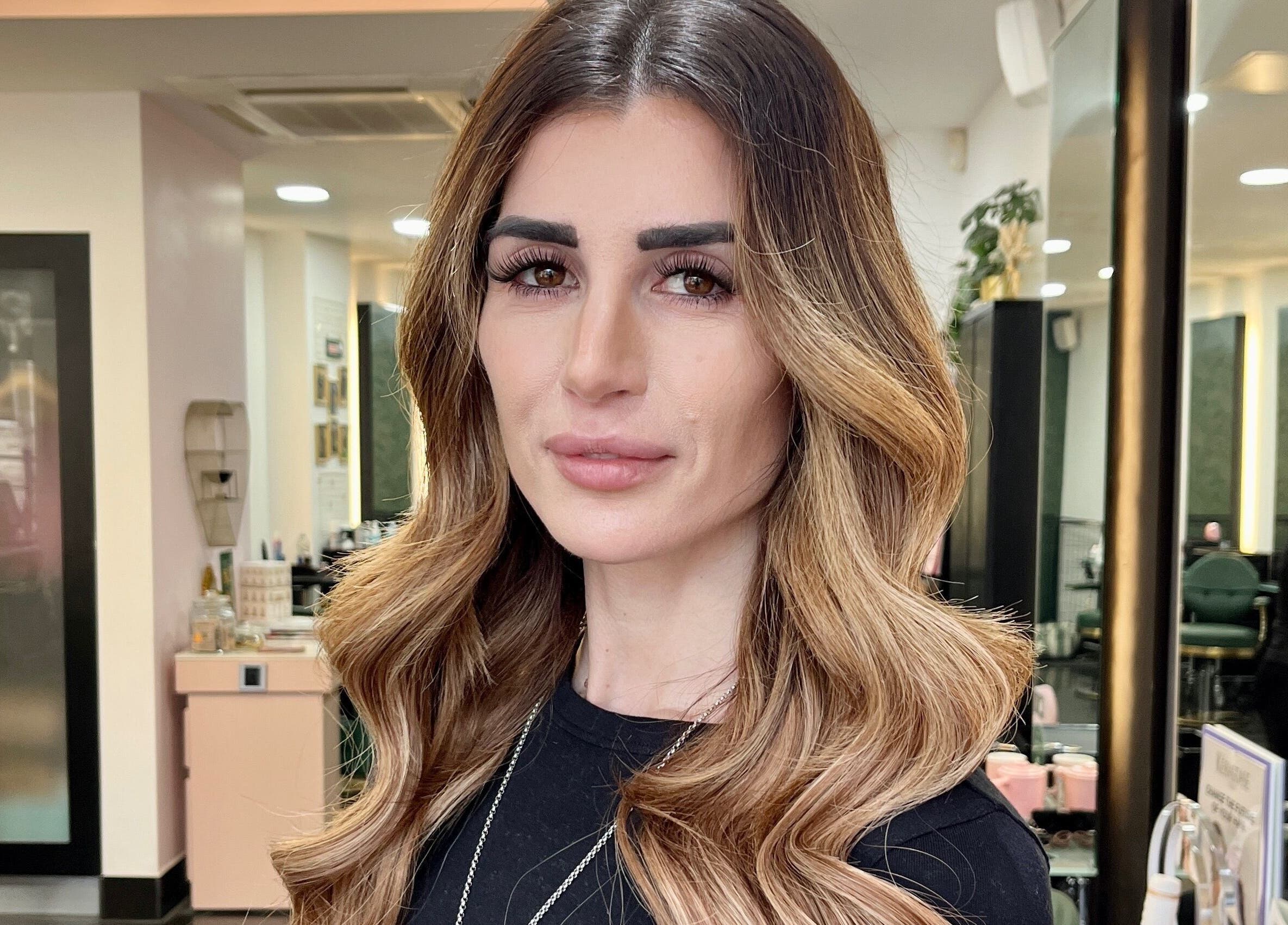 Portrait of a woman with styled hair at Aura Extensions, Twickenham, England, GB beauty salon.