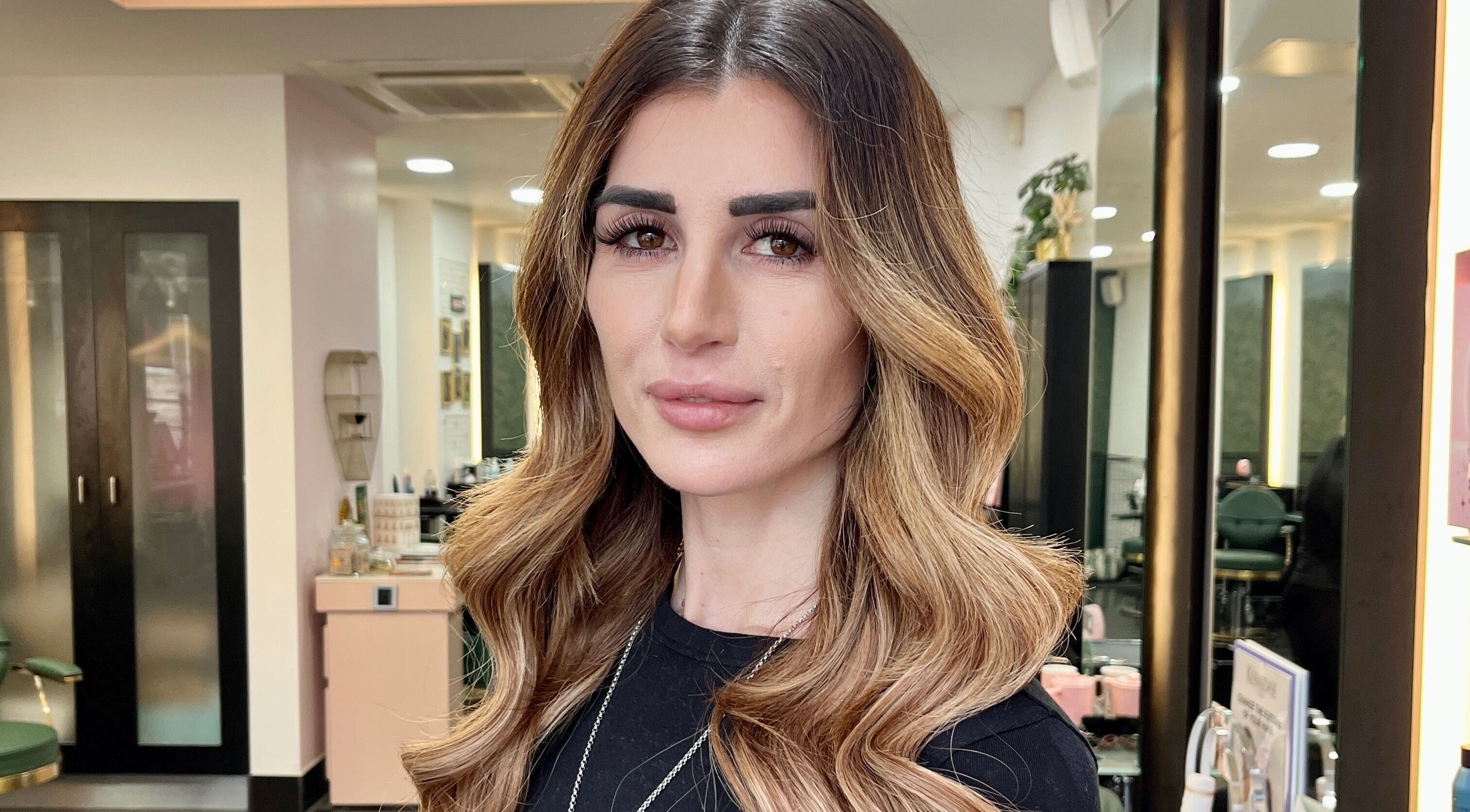 Portrait of a woman with styled hair at Aura Extensions, Twickenham, England, GB beauty salon.