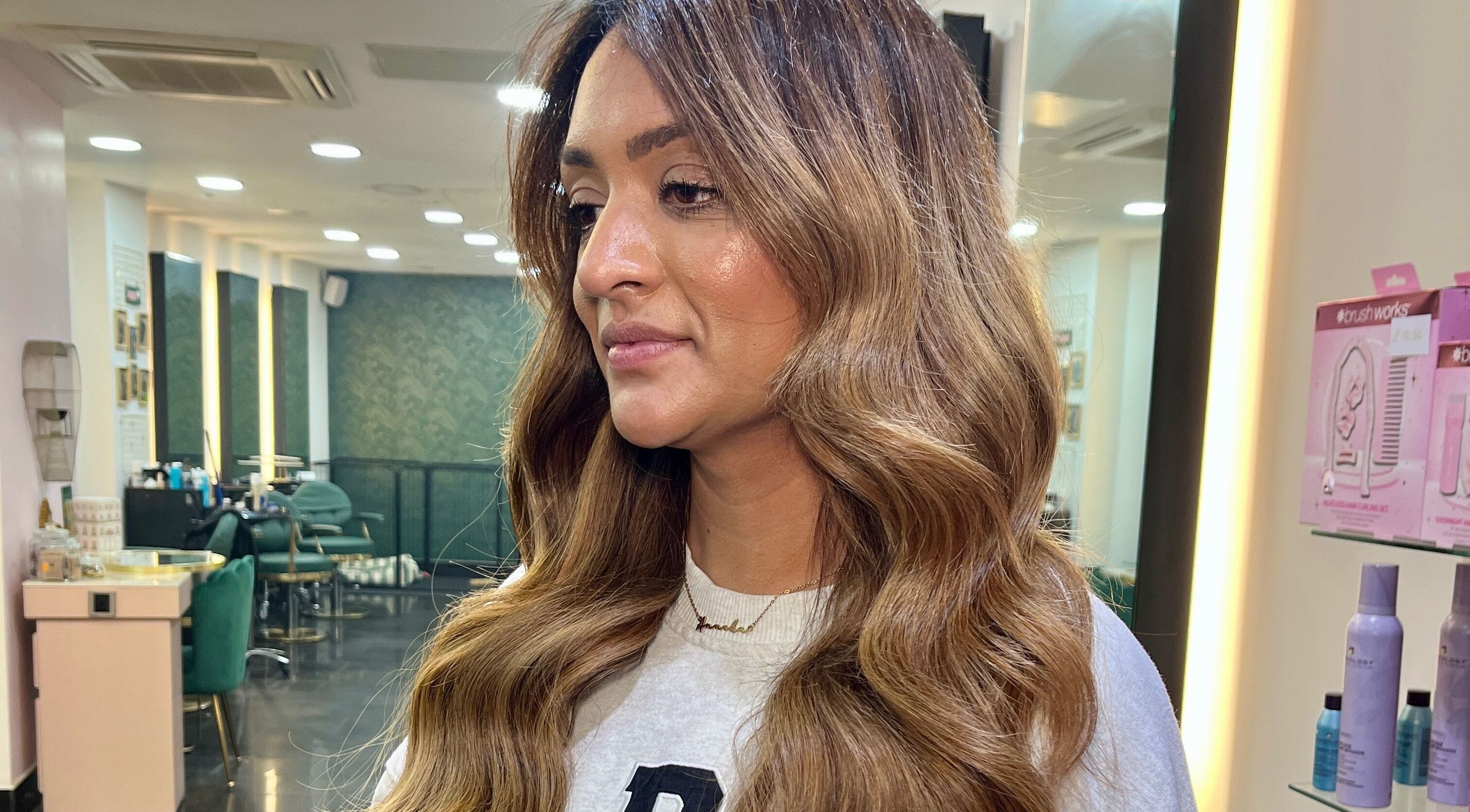 Warm-toned hair styled with waves at Aura Extensions, Twickenham, England, GB salon interior.