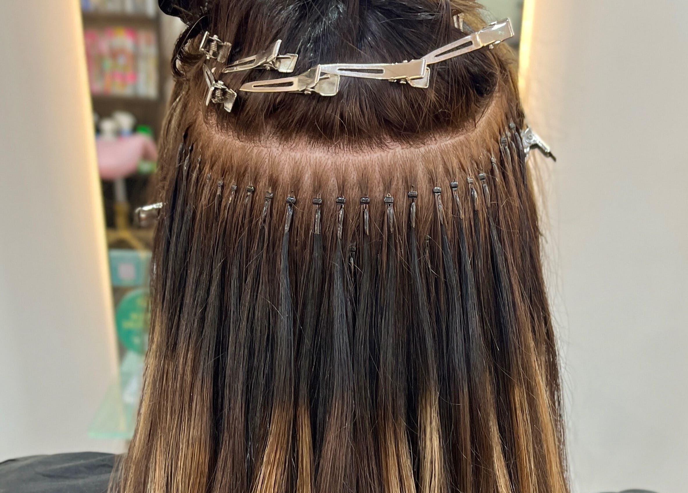 Close-up of hair extensions in progress at Aura Extensions, Twickenham, England, GB.