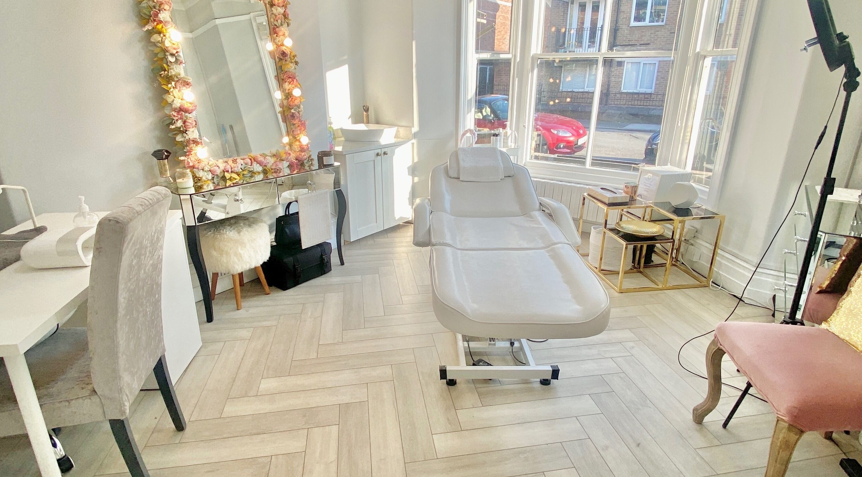 Bright, chic treatment room at Zoe Hines Aesthetics, England, England, GB, featuring a plush reclining chair.
