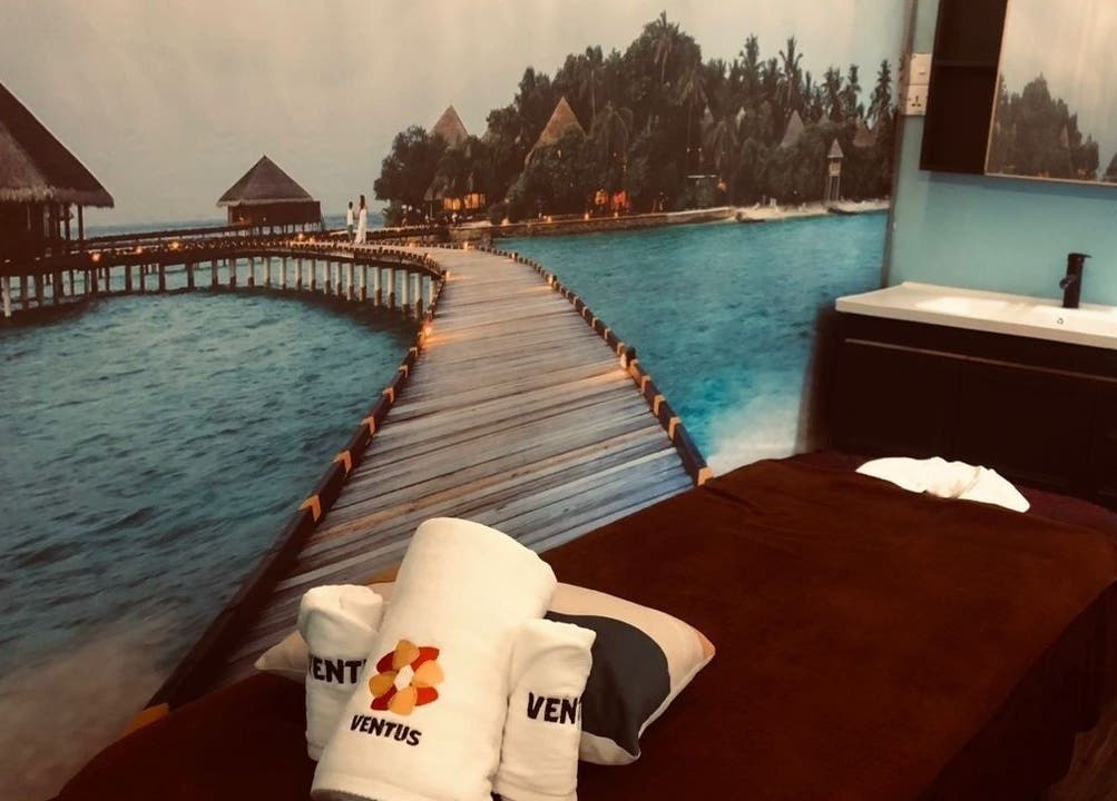 Relaxing massage room at Ventus Spa 沙巴亚庇正宗精油按摩会所, Kota Kinabalu, Sabah, MY with serene island mural.