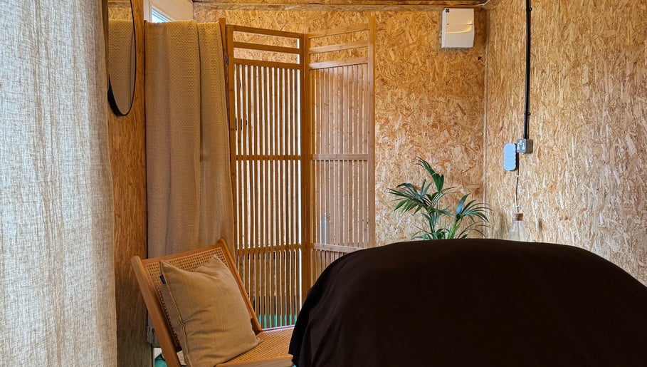 Cozy massage room at Massage Margate with soft lighting and wood decor, located in Margate, GB.