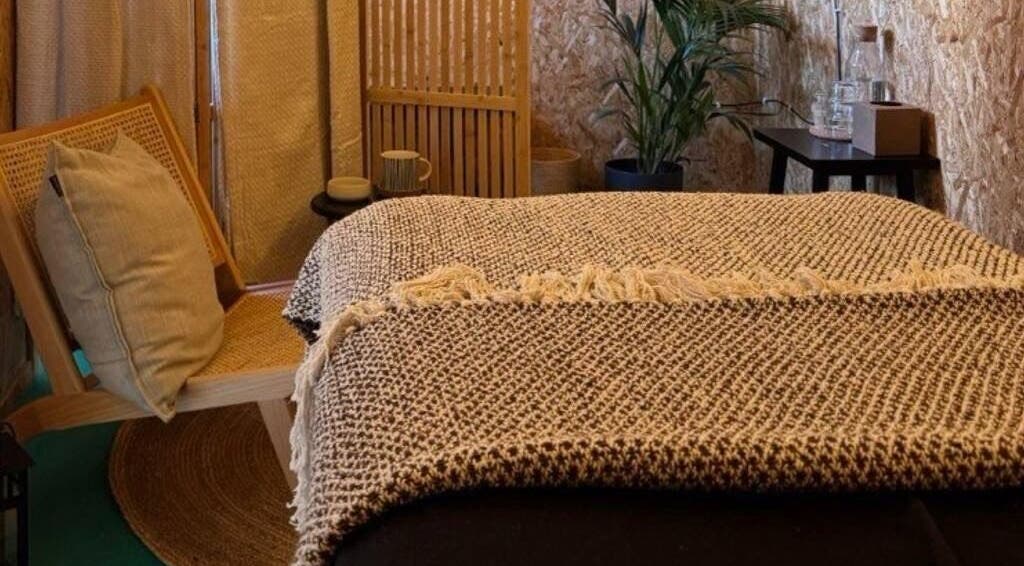 Relaxing therapy room at Massage Margate, Margate, GB with a rustic chair and a comfy massage bed.