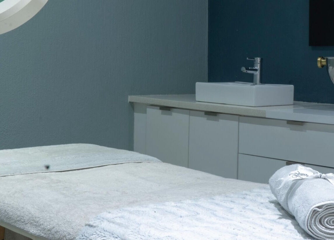 Tranquil treatment room at Aqua Spa & Skin, Surf Village, Jeffreys Bay, Eastern Cape, ZA with sleek furnishings.