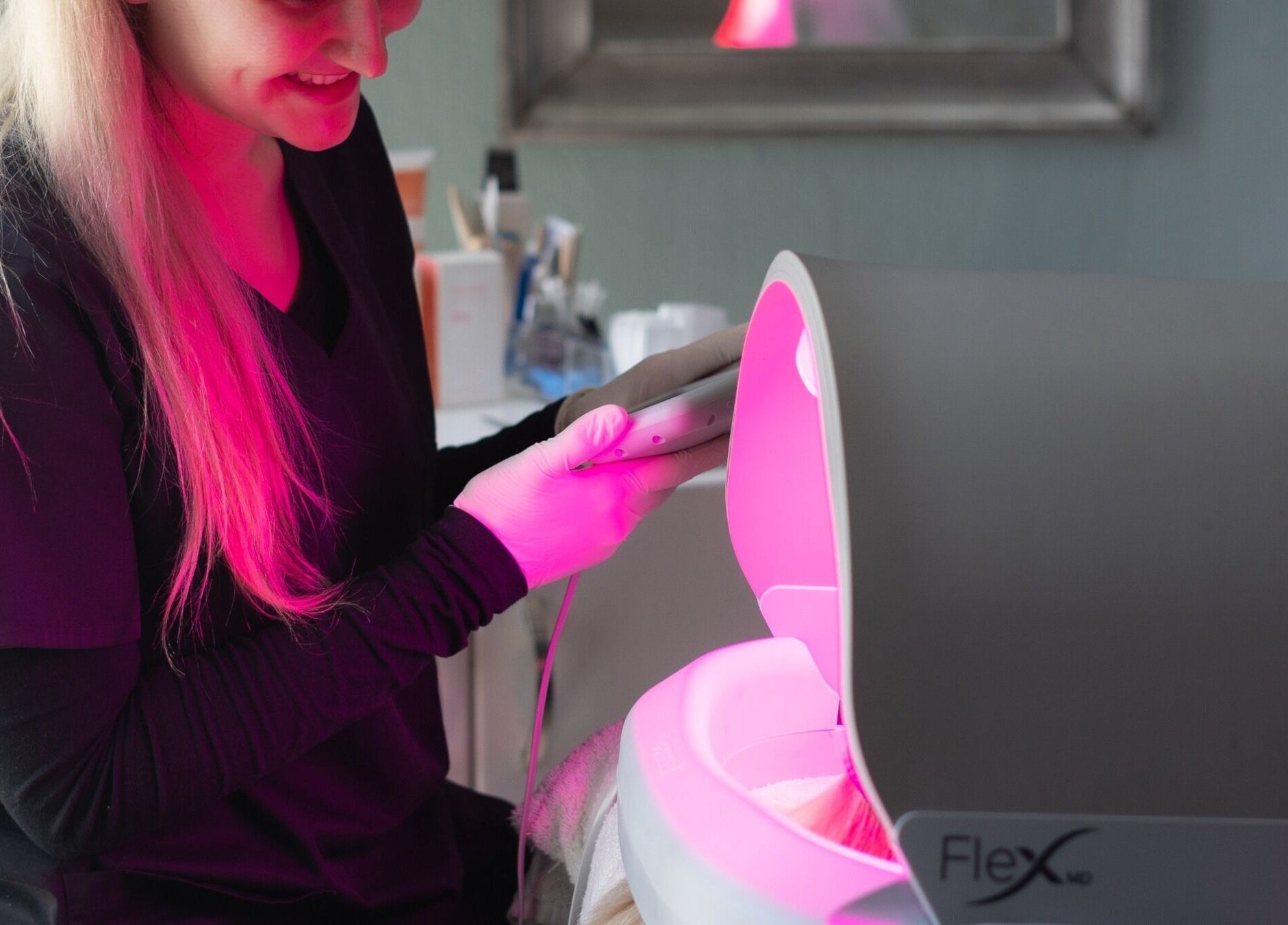 Therapist using LED device at Aqua Spa & Skin, Surf Village, Jeffreys Bay, Eastern Cape, ZA.