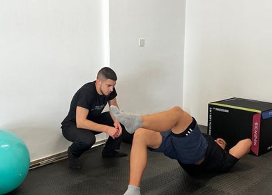 Physiotherapist guides exercise at Theramotion Physiotherapy, Λευκωσία, Λευκωσία, CY.