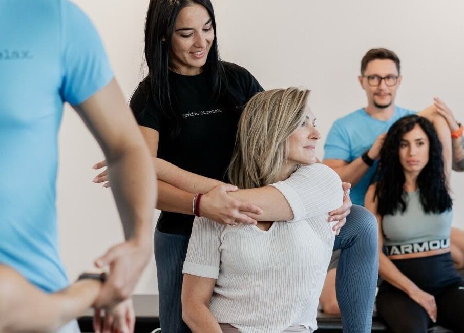 Instructors assisting stretches at Stretch Centar Beograd, Beograd, RS, enhancing wellness and flexibility.