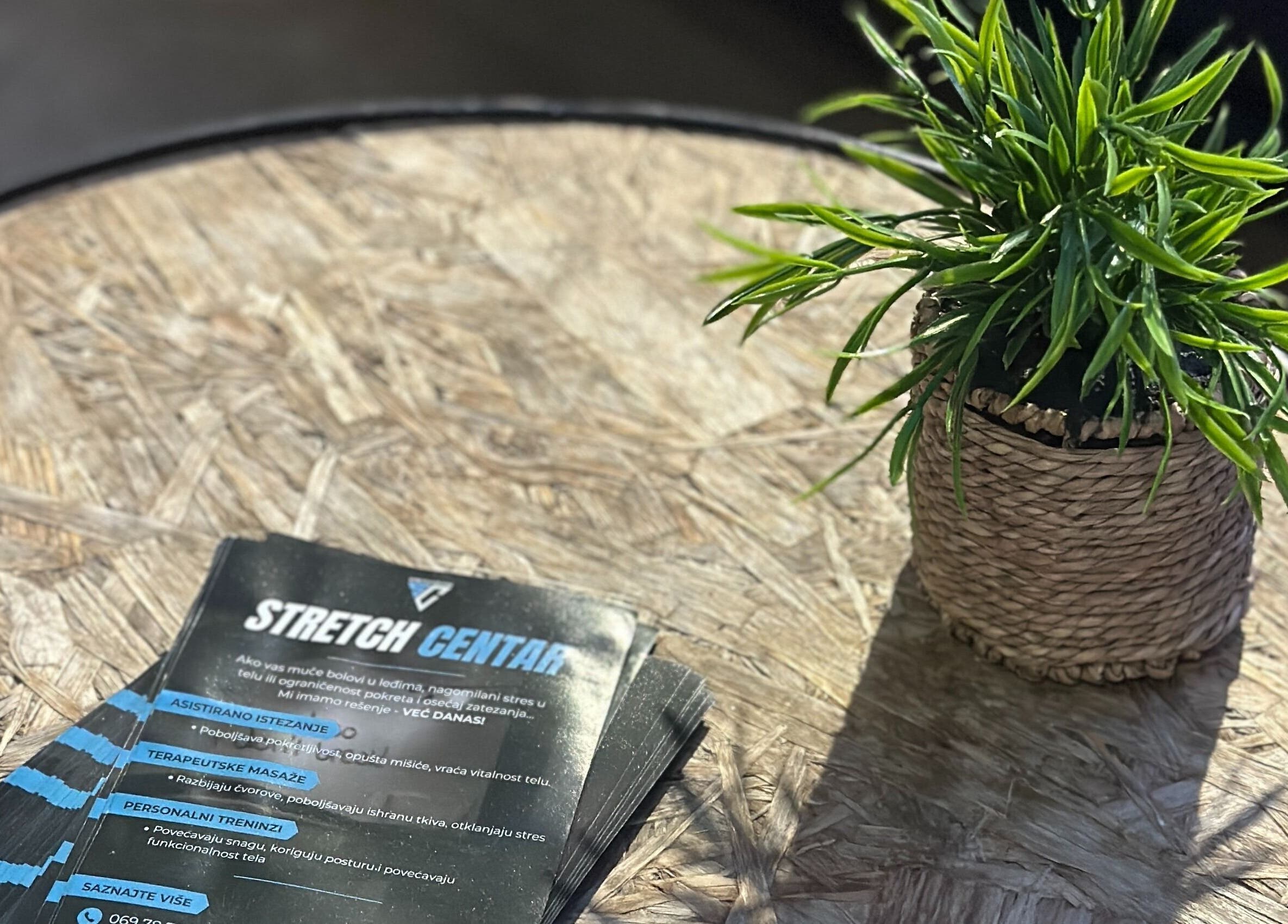 Flyers for Stretch Centar Sarajevska 36 on a wood table with plant, Beograd, RS.