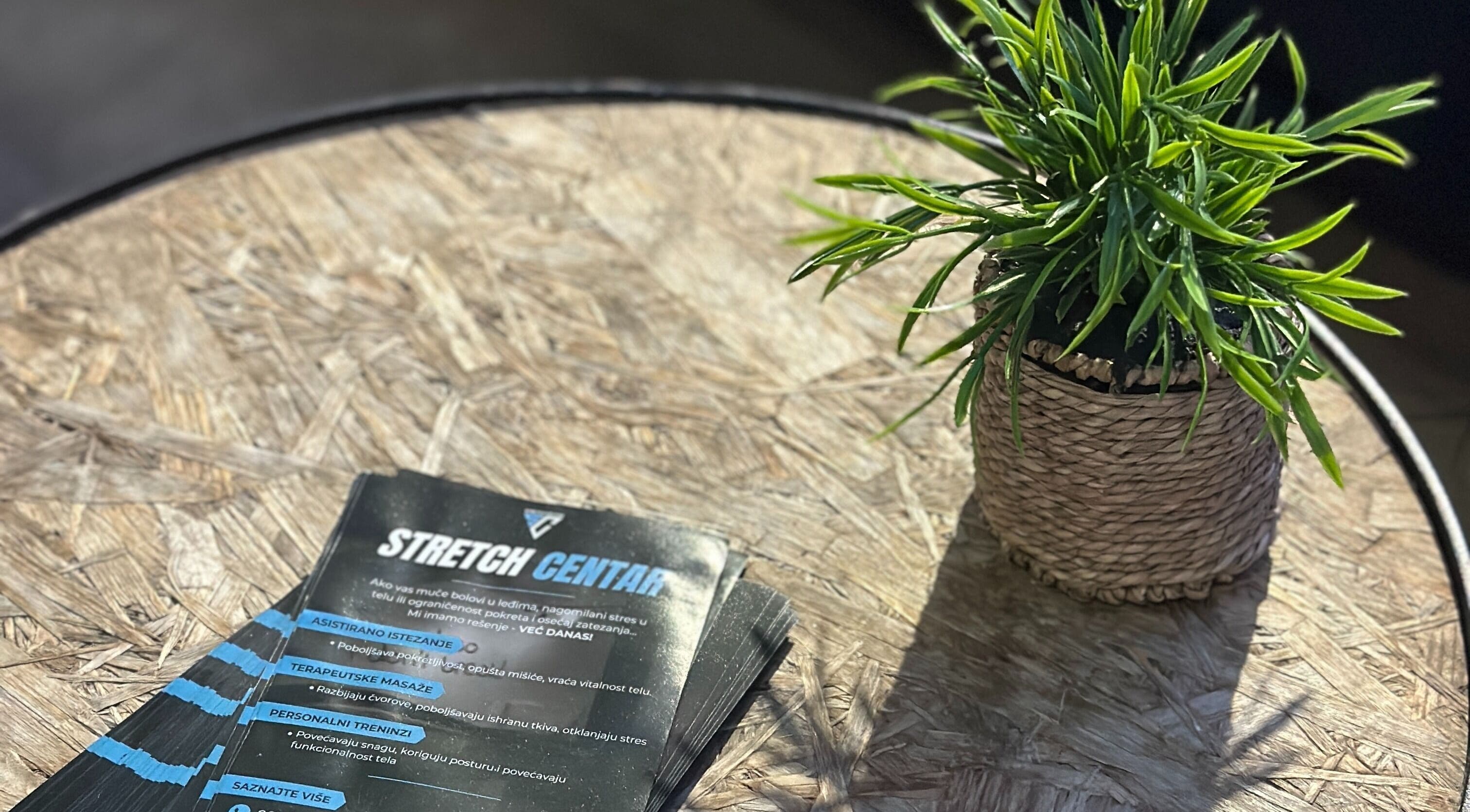 Flyers for Stretch Centar Sarajevska 36 on a wood table with plant, Beograd, RS.