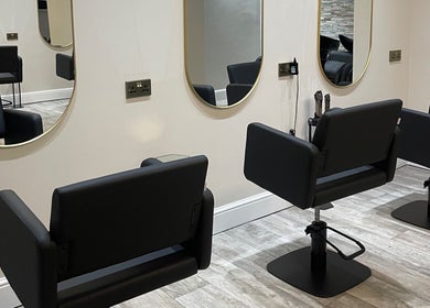 Elegant salon chairs and mirrors at Cabello Lounge, Southampton, England, GB, showcasing a modern aesthetic.