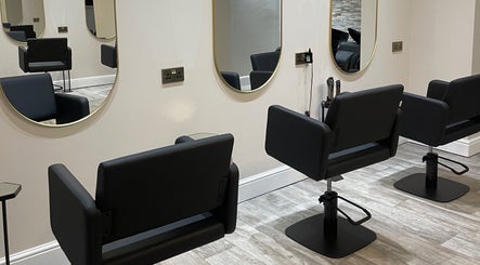 Elegant salon chairs and mirrors at Cabello Lounge, Southampton, England, GB, showcasing a modern aesthetic.