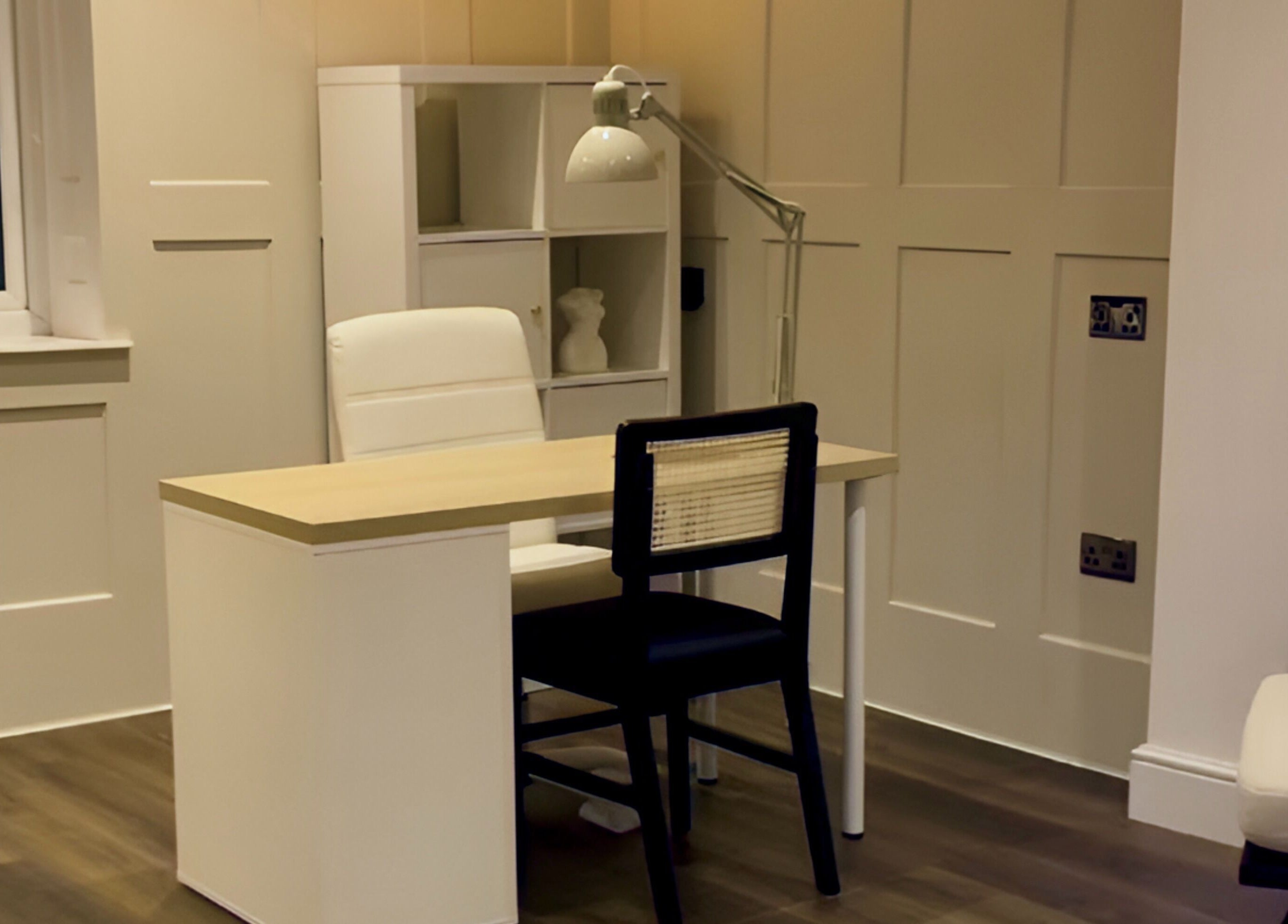 Modern treatment room at ByChloeAllen, Tamworth, England, GB featuring a stylish desk and chair.