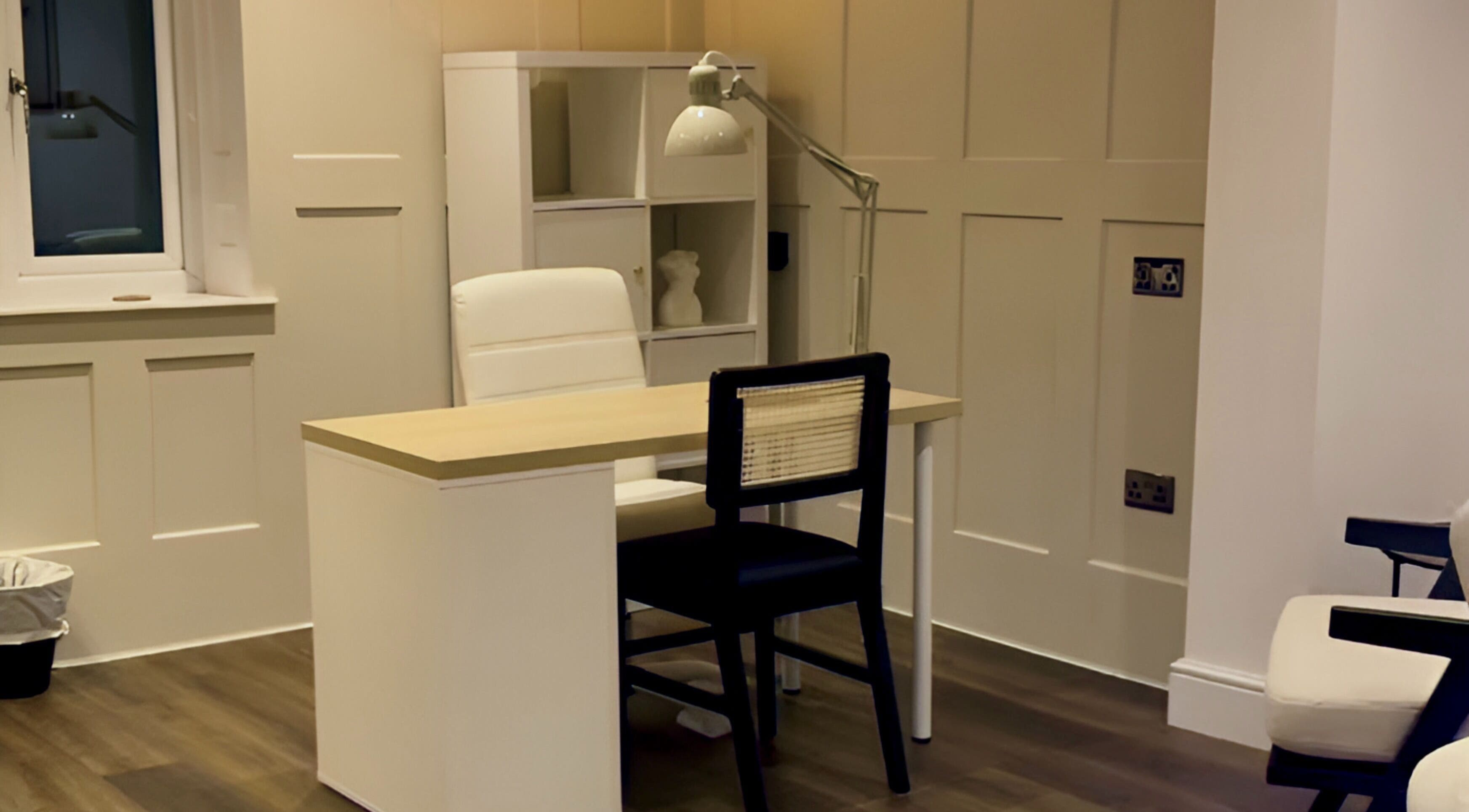 Modern treatment room at ByChloeAllen, Tamworth, England, GB featuring a stylish desk and chair.