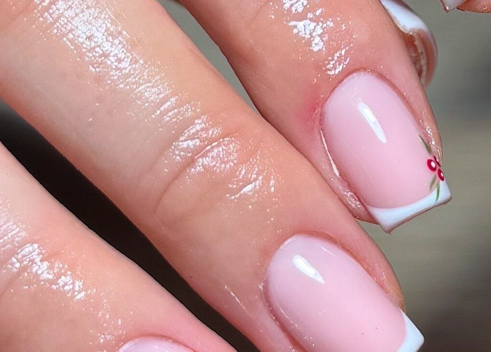 Elegant French manicure with floral design at ByChloeAllen, Tamworth, England, GB.