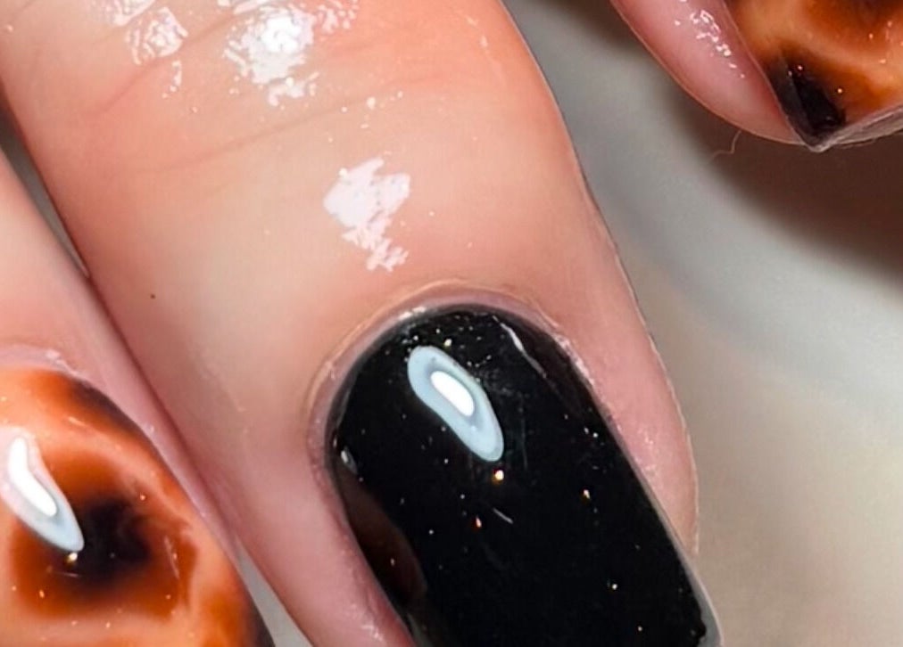 Detailed black and tortoiseshell manicure by ByChloeAllen in Tamworth, England, GB.