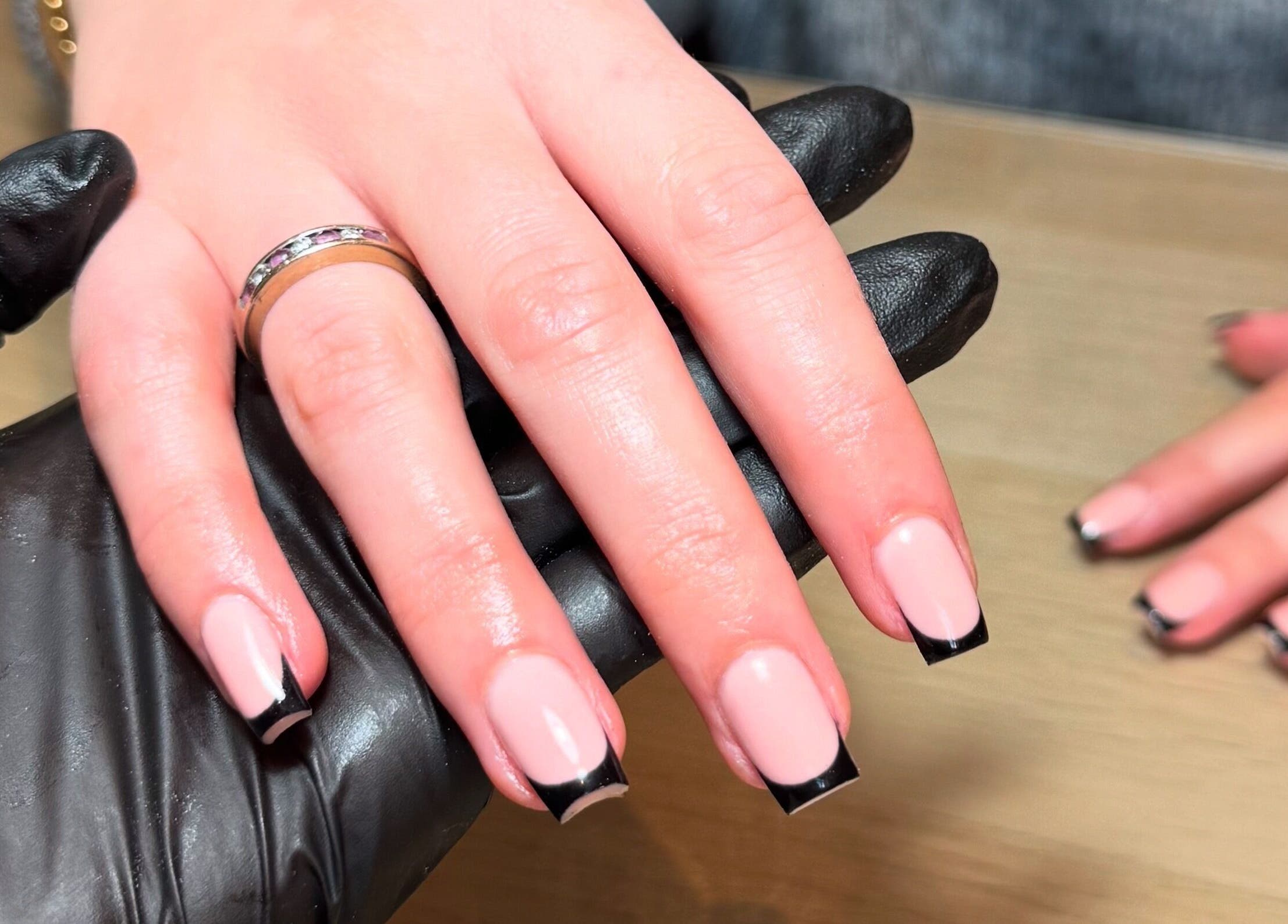 Elegant manicured nails at ByChloeAllen in Tamworth, England, GB. Black tips on pink polish showcase stylish nail art.