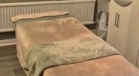 Serene massage room at The Beauty Retreat, Eastbourne, England, GB, featuring a plush treatment bed.