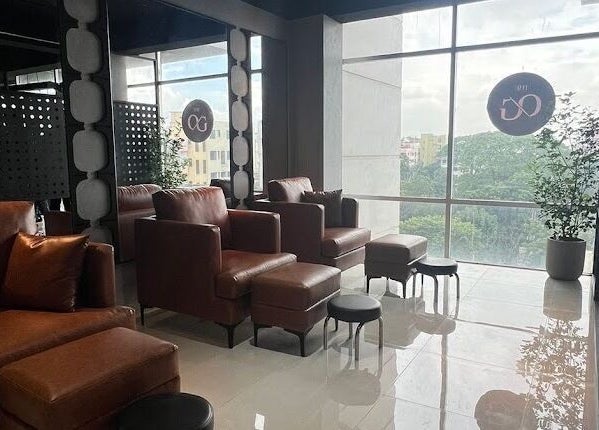 Elegant lounge area at The Original Groomers, Dhaka, Dhaka Division, BD, with leather chairs and large windows.