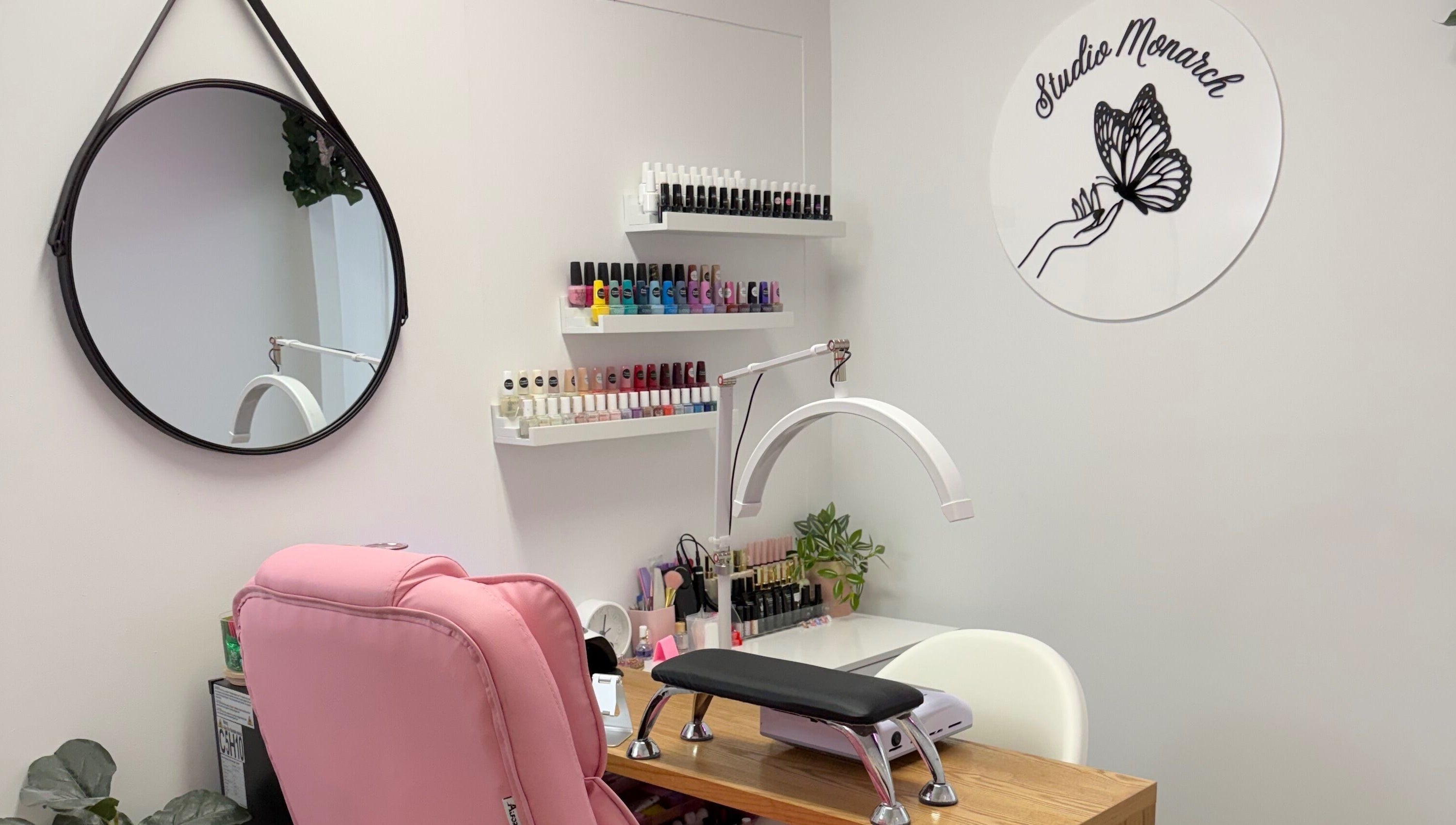 Chic nail station at Studio Monarch by Leia Ebert, Bundall, Queensland, AU, featuring colorful nail polishes.